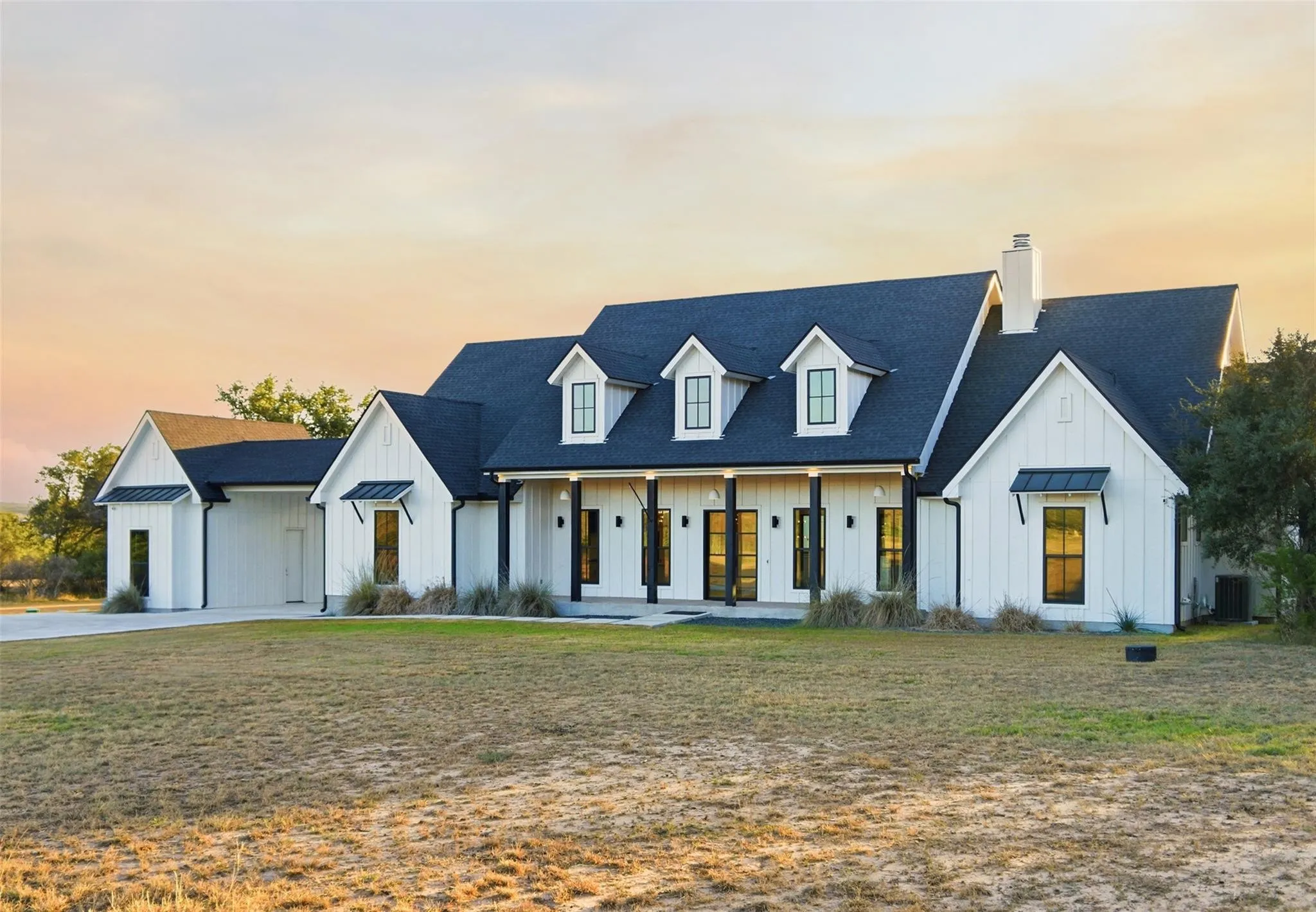 White farmhouse and front porch in warm morning light