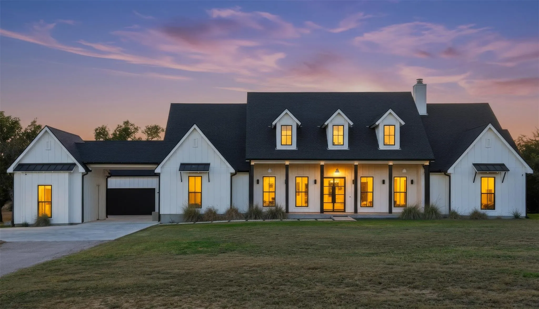 White farmhouse under a pink Texas sunset